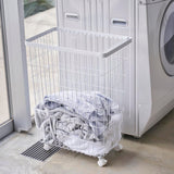 洗濯機前にランドリーバスケットを置いたシーン